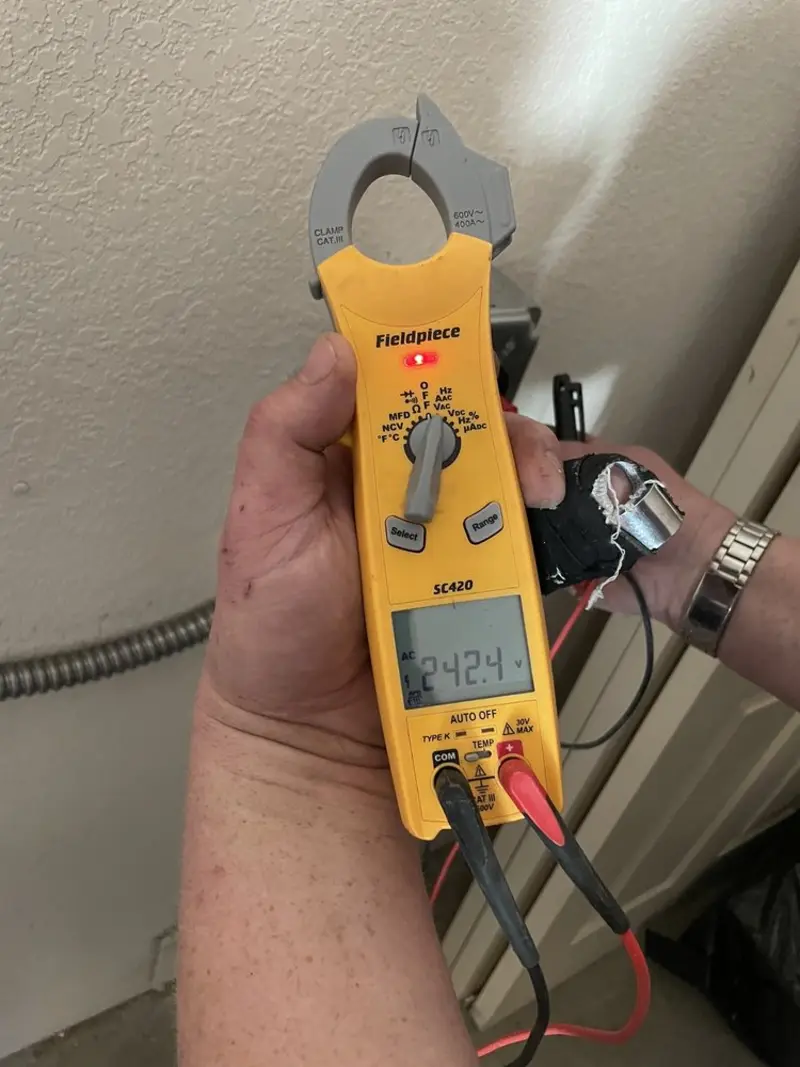 Voltage testing with clamp meter during Recessed Lighting Installation in Dedham
